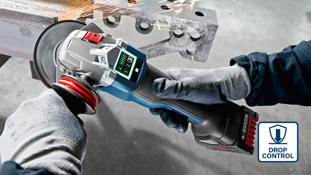 A Bosch Professional angle grinder sparks while cutting metal, held in gloved hands.