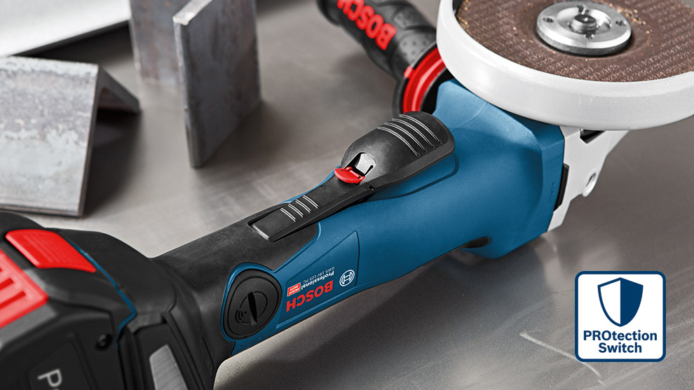 A Bosch Professional angle grinder on a metal surface beside metal blocks and a grinding disc.