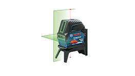 A Bosch Professional laser level projects green lines on a wall, showing precise alignment.