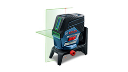 A Bosch Professional laser level projects a green line on a wall.